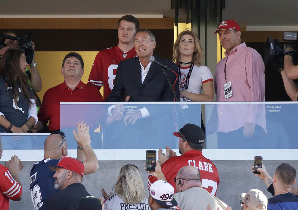 Former San Francisco 49ers receiver Dwight Clark, center (in dark jacket), died on Monday after a three-year battle with ALS. He was 61 years old. (AP)