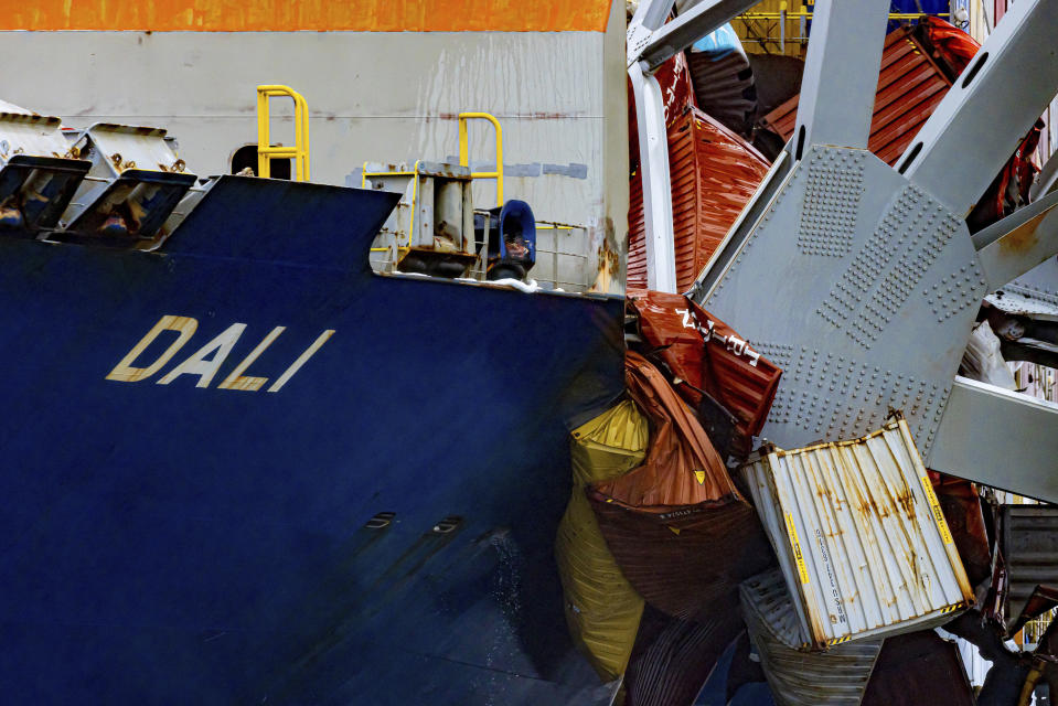 Containers are crushed as wreckage of the Francis Scott Key Bridge rests on the container ship Dali, Wednesday, April 3, 2024, in Baltimore. (AP Photo/Julia Nikhinson)