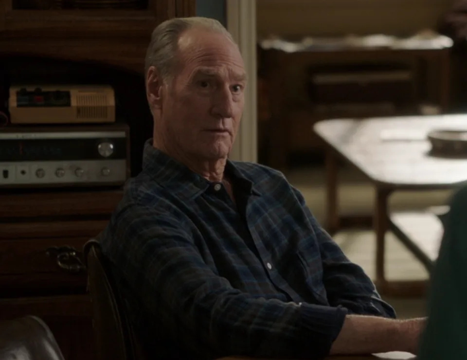 Dale in a plaid shirt sitting