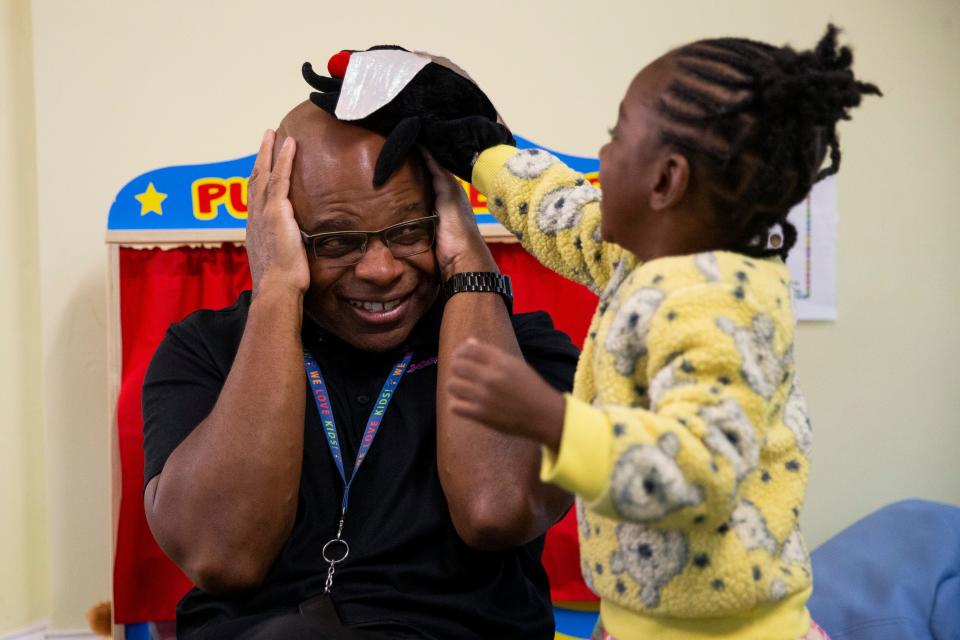 Eric Harris, the founder of Equity to Prosperity, smiles as he pretends to hide from the fly puppet Harmonee, 3, lands on his head during the Equity 2 Prosperity program in Memphis, Tenn., on Thursday, September 7, 2023.
