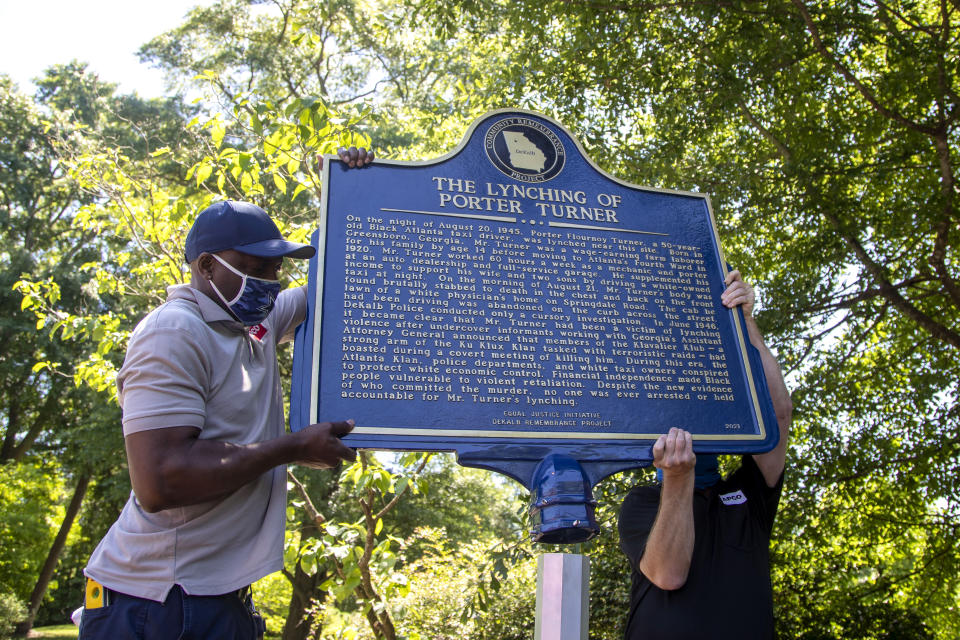 A historical marker that tells the story of the lynching of Porter Flournoy Turner is installed in Atlanta's Druid Hills community, Thursday, May 6, 2021. Porter Turner was lynched near the area in August 1945. (Alyssa Pointer/Atlanta Journal-Constitution via AP)