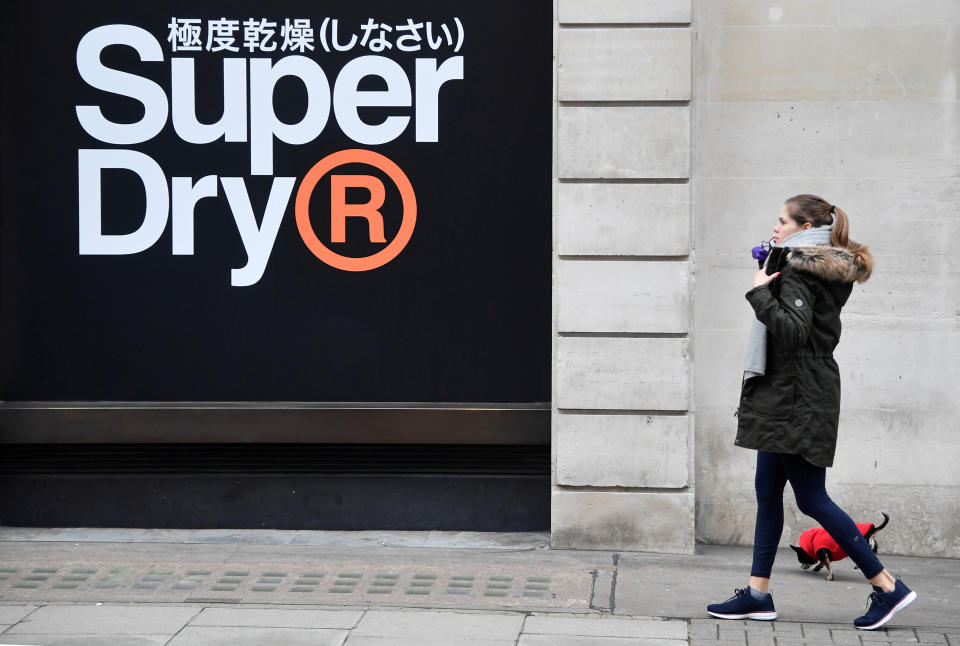 A woman walks past a window display at a Superdry store in London, Britain, March 1, 2019. REUTERS/Toby Melville