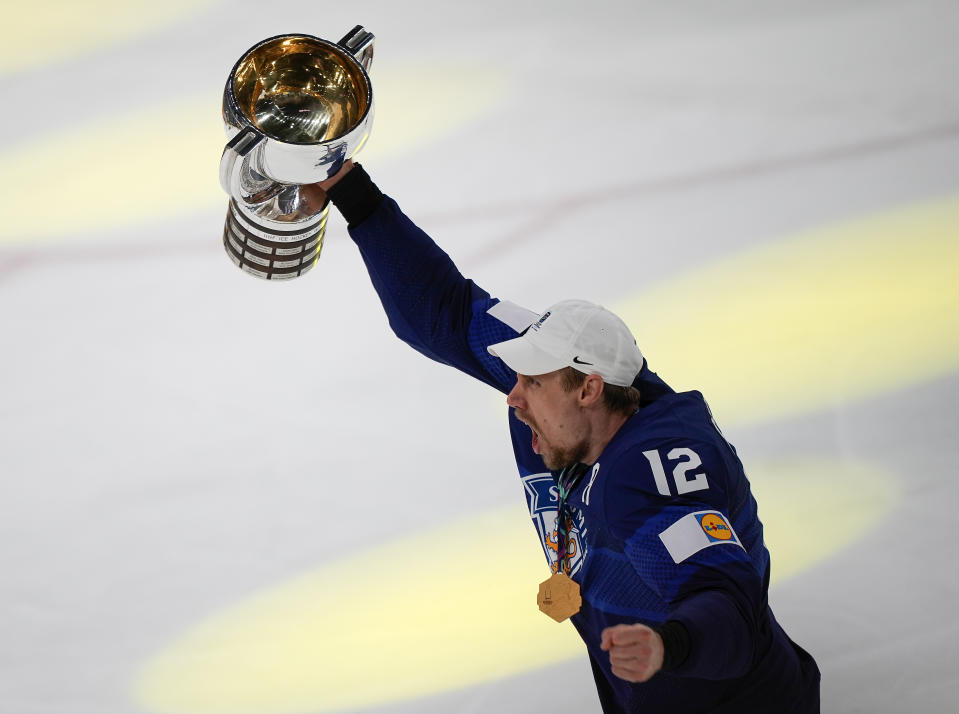 Finland's Marko Anttila celebrates with the trophy after winning the Hockey World Championship final match between Finland and Canada in Tampere, Finland, Sunday May 29, 2022. Finland became world champion after beating Canada 4-3 in overtime. (AP Photo/Martin Meissner)