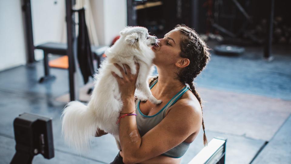 Woman kissing puppy