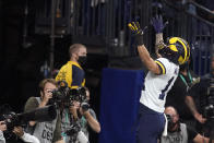Michigan wide receiver Roman Wilson celebrates after catching a 75-yard touchdown pass during the first half of the Big Ten championship NCAA college football game against Iowa, Saturday, Dec. 4, 2021, in Indianapolis. (AP Photo/Darron Cummings)