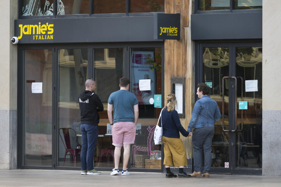 CARDIFF, UNITED KINGDOM - MAY 21: People look into the window of a Jamies Italian restaurant on the Hayes on May 21, 2019 in Cardiff, United Kingdom. More than 1,000 jobs are at risk after the chain of restaurants belonging to celebrity chef Jamie Oliver has been placed into administration. Just under forty restaurants including the Jamies Italian, Fifteen and Barbecoa brand are now at risk of closure. The business had been seeking buyers due to stiff competition in the market. (Photo by Matthew Horwood/Getty Images)