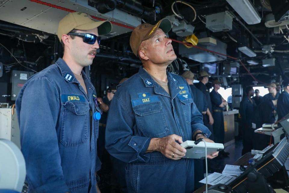 The commanding officer of USS Leyte Gulf navigates the  Ticonderoga-class guided-missile cruiser alongside a navigator