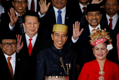FILE PHOTO: Indonesia president Joko Widodo (C) with his wife Iriana (R) with parliament members pose for pictures after delivering a speech in front of parliament members ahead of Thursday's independence day in Jakarta, Indonesia, August 16, 2017. REUTERS/Beawiharta/File Photo