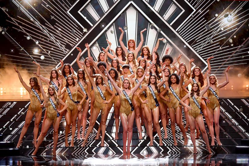 The contestants of Miss France 2024 pose onstage.