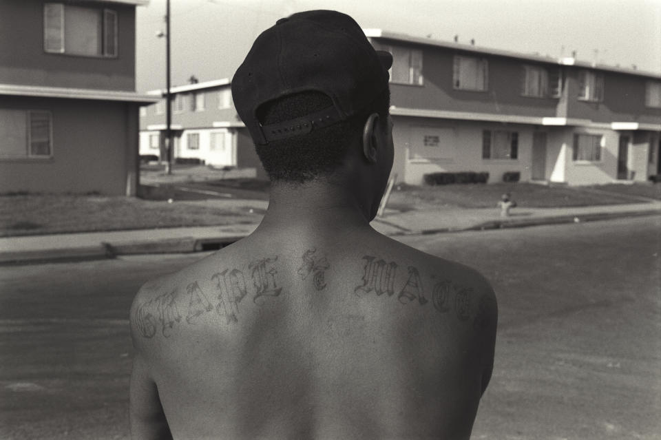 An OG, or "original gangster," member of the Grape Street Crips shows off his tattoo.<span class="copyright">Axel Koester—Corbis/Getty Images</span>