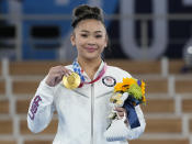 Gold medallist Sunisa Lee of the Unites States displays her medal for the artistic gymnastics women's all-around at the 2020 Summer Olympics, Thursday, July 29, 2021, in Tokyo. (AP Photo/Gregory Bull)