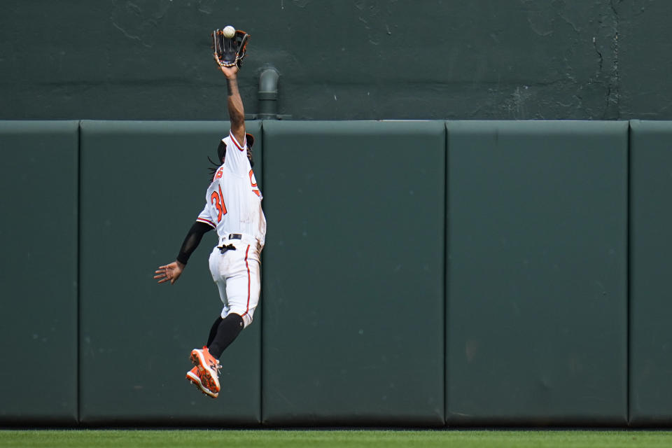 Baltimore Orioles center fielder Cedric Mullins makes a catch on a ball hit by Chicago White Sox's Tim Anderson during the second inning of a baseball game, Wednesday, Aug. 30, 2023, in Baltimore. (AP Photo/Julio Cortez)