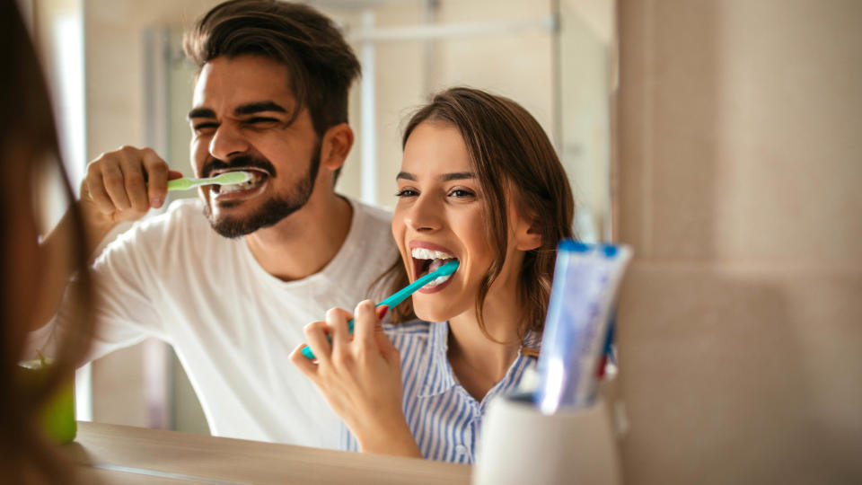 Couple brushing their teeth