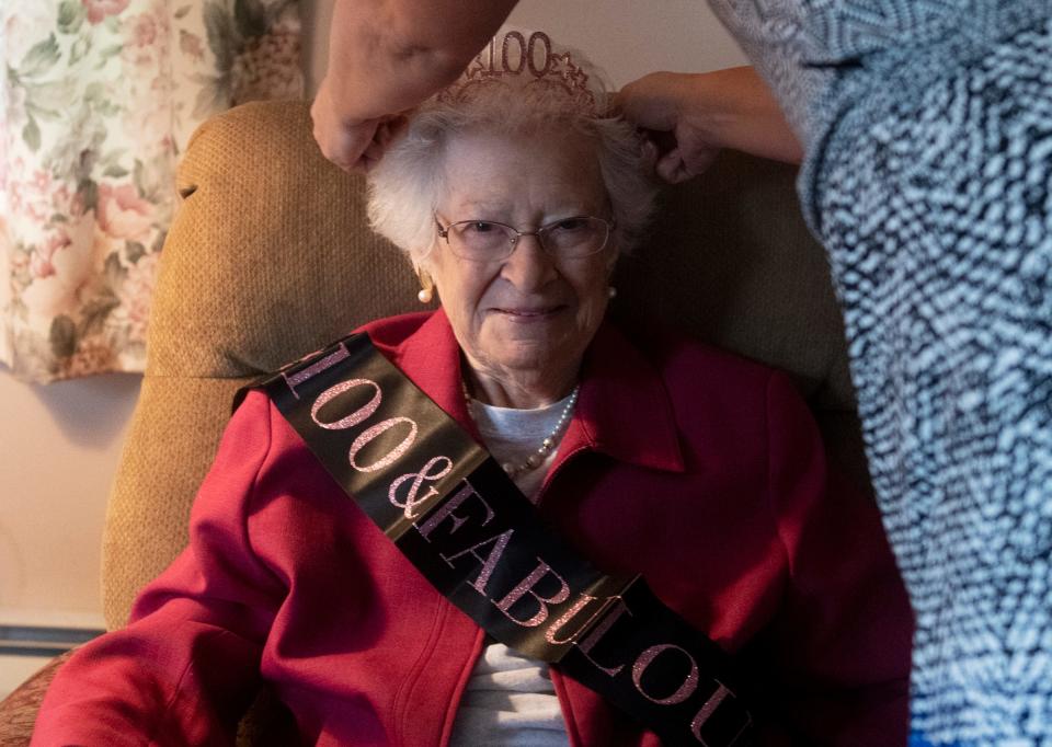Audrey Smith smiles as her granddaughter, Lisa Baker, places a tiara on her head. The Randolph native  turns 100 on Sunday.