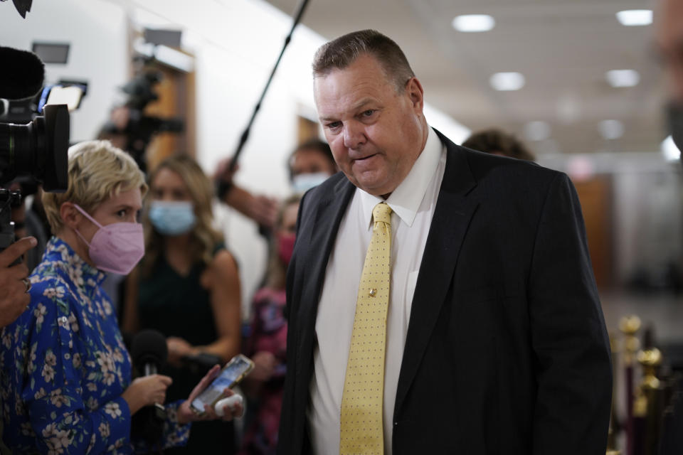 Sen. Jon Tester, D-Mont., stops for reporters asking about the fate of President Joe Biden's $3.5 trillion plan for social and environmental spending, at the Capitol in Washington, Tuesday, Sept. 21, 2021. (AP Photo/J. Scott Applewhite)