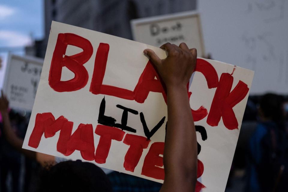 A person holds up a placard that reads, 'Black lives matter' during a protest in the city of Detroit, Michigan, on May 29, 2020: SETH HERALD/AFP via Getty Images