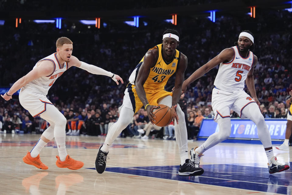 New York Knicks guard Donte DiVincenzo and forward Precious Achiuwa (5) guard Indiana Pacers forward Pascal Siakam (43) during the first half of Game 7 in an NBA basketball second-round playoff series, Sunday, May 19, 2024, in New York. (AP Photo/Julia Nikhinson)
