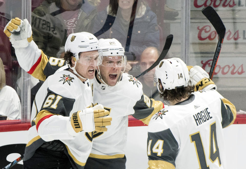 Vegas Golden Knights' Paul Stastny (26) celebrates with teammates Mark Stone (61) and Nicolas Hague after scoring during second-period NHL hockey game action against the Montreal Canadiens in Montreal, Saturday, Jan. 18, 2020. (Graham Hughes/The Canadian Press via AP)