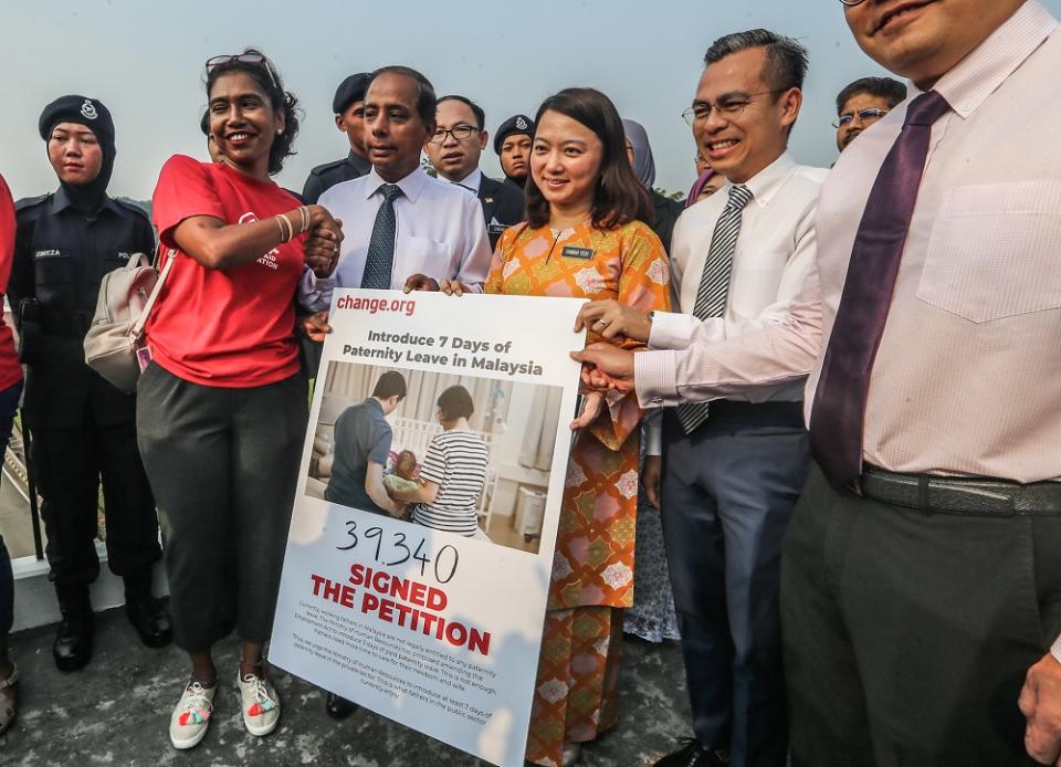 WAO executive director Sumitra Visvanathan hands over a petition to press for paternity leave in the private sector to be extended from three days to seven outside the Parliament in Kuala Lumpur November 13, 2019. — Pictures by Firdaus Latif