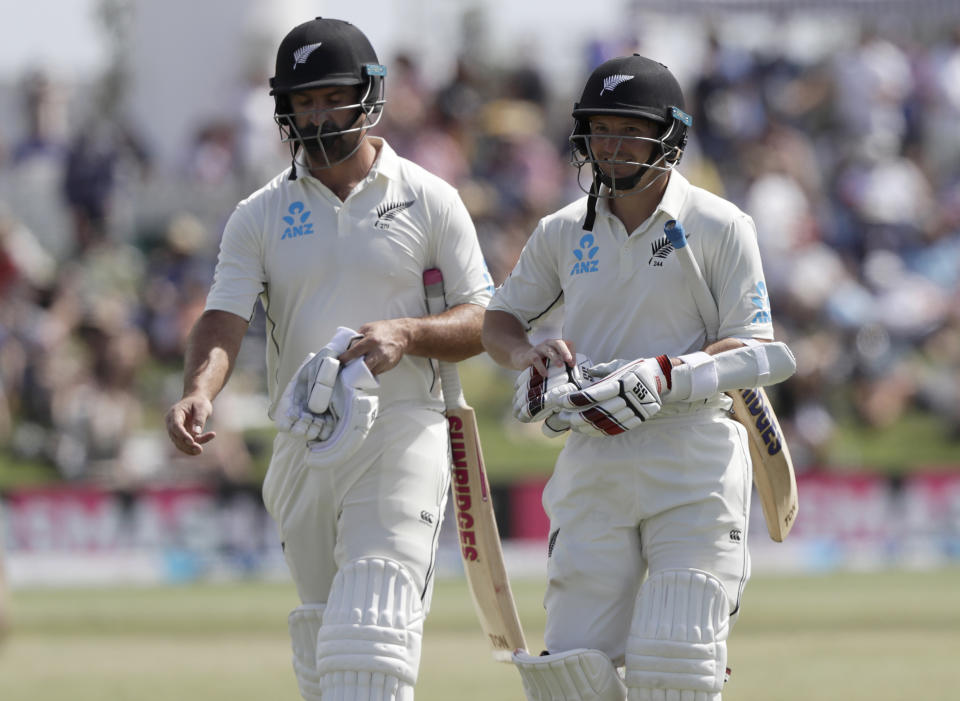 Not out New Zealand batsmen Colin de Grandhomme, left, and BJ Watling walk from the field at tea during play on day three of the first cricket test between England and New Zealand at Bay Oval in Mount Maunganui, New Zealand, Saturday, Nov. 23, 2019. (AP Photo/Mark Baker)