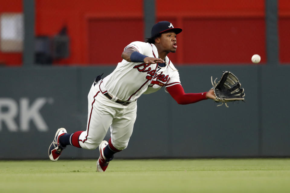 Atlanta Braves center fielder Ronald Acuna Jr. dives to catch a fly ball by Los Angeles Dodgers' Corey Seager with the bases loaded for the final out in the second inning of a baseball game Saturday, Aug. 17, 2019, in Atlanta. (AP Photo/John Bazemore)