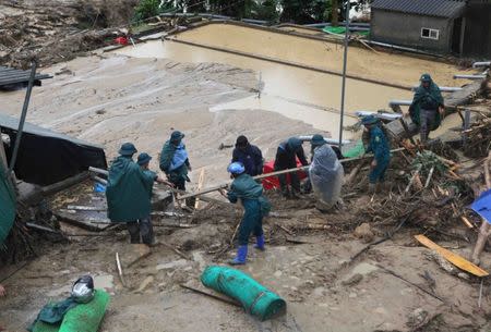 Paramilitary clear debris of a landslide in Lai Chau province, Vietnam June 25, 2018. VNA/Quy Trung via REUTERS