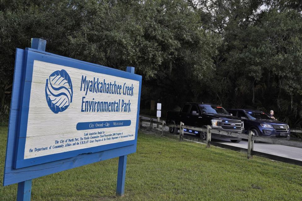 North Port, Fla., police officer block the entrance to the Myakkahatchee Creek Environmental Park Wednesday, Oct. 20, 2021, in North Port, Fla.