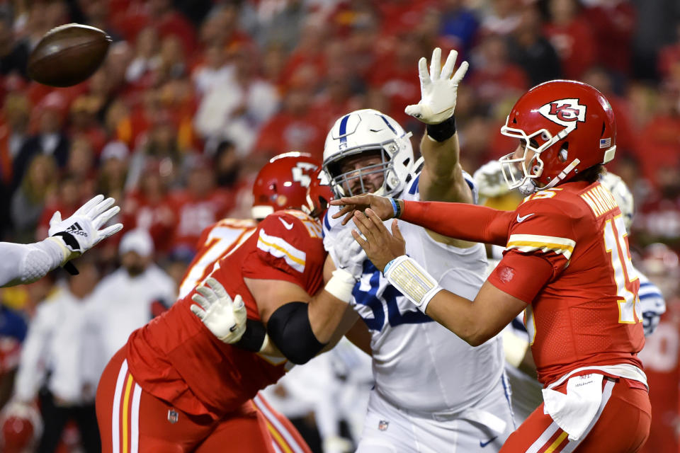 Kansas City Chiefs quarterback Patrick Mahomes (15) throws under pressure from Indianapolis Colts defensive tackle Margus Hunt (92) during the first half of an NFL football game in Kansas City, Mo., Sunday, Oct. 6, 2019. (AP Photo/Ed Zurga)