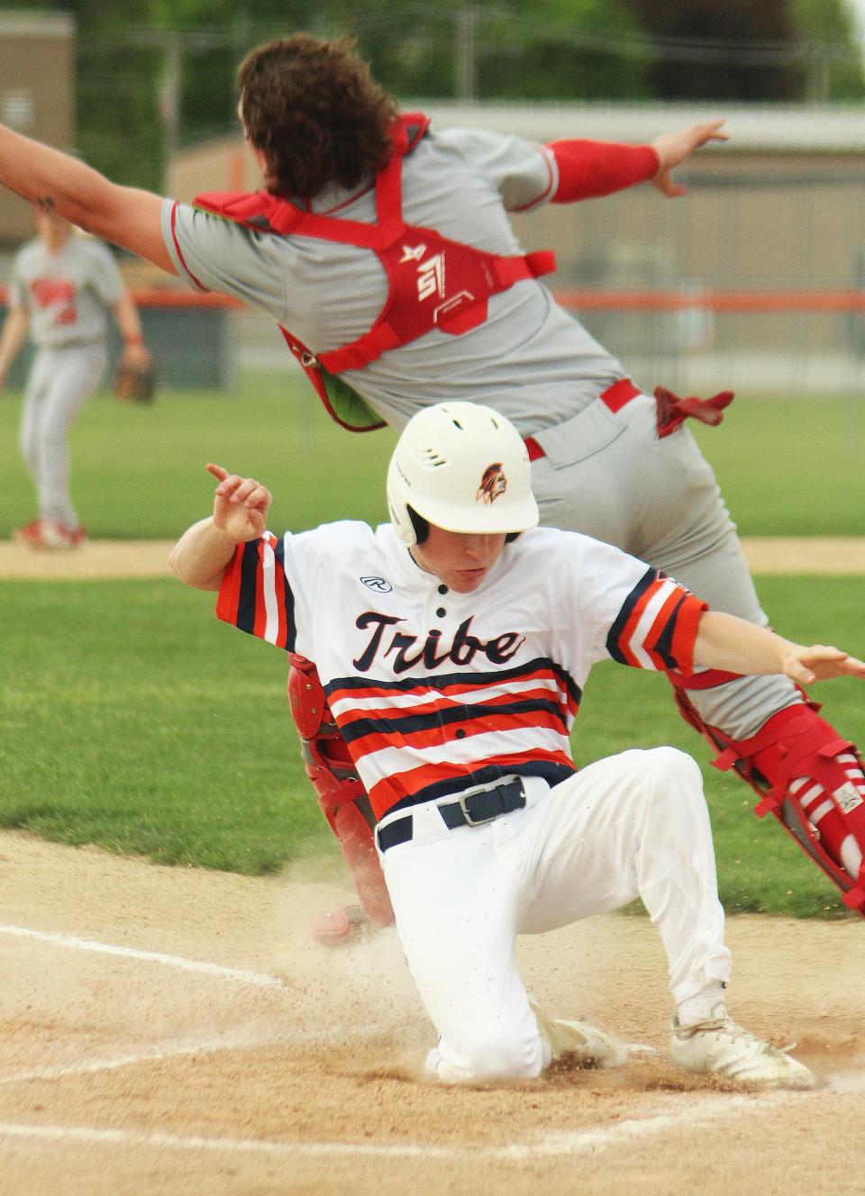 Jacob Fogarty slides safely into home plate with one of Pontiac's seven first-inning runs against Ottawa Thursday. PTHS shut out the Pirates 11-0 behind Henry Brummel's no-hitter.