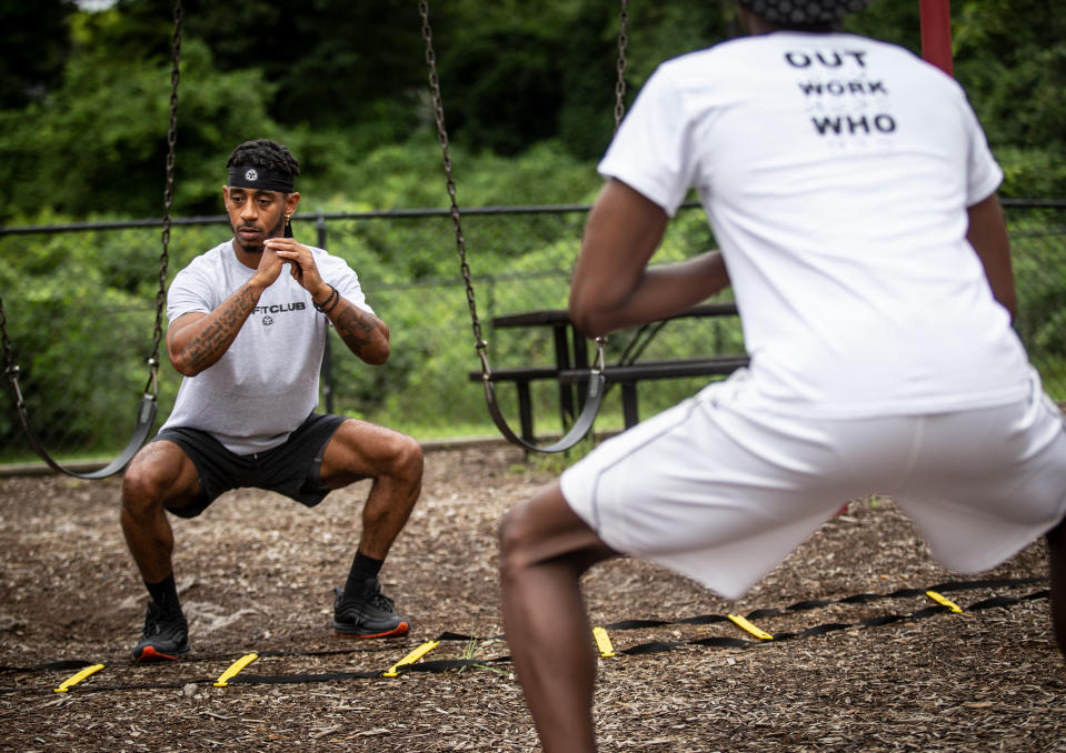 Sakai Harrison, left, leads his clients through a rigorous workout on Wednesday, July 29, 2020, in Atlanta. Harrison moved to New York to try to make it as a personal trainer and designer - but his gym shuttered early in the pandemic, and after weeks of struggling to both pay the rent and put food in his fridge, he knew what he had to do. He moved back to Georgia for greater stability. (AP Photo/Ron Harris)