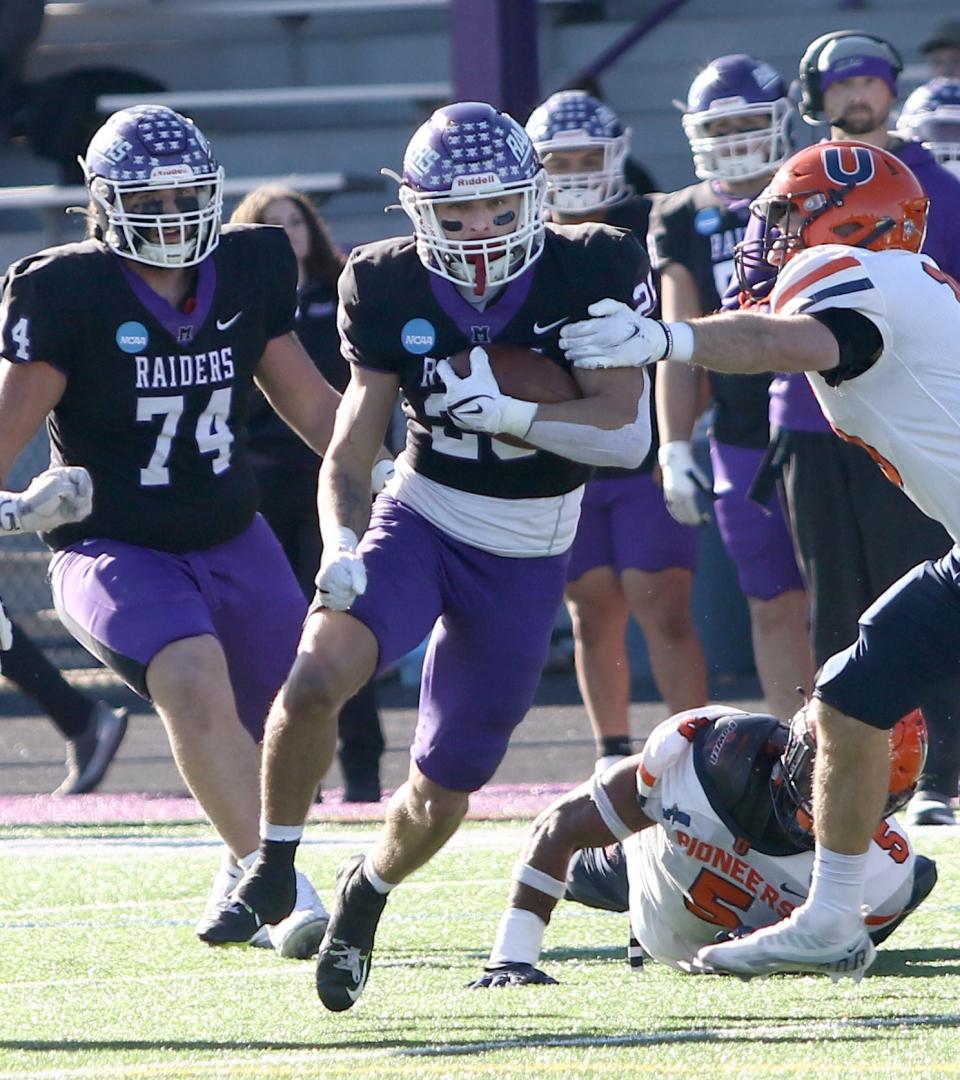 Mount Union's Tyler Echeverry carries the ball against Utica during an NCAA Division III playoff game on Saturday, November 26, 2022.
