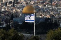 An Israeli flag flutters as the Dome of the Rock on the compound known to Jews as Temple Mount and to Palestinians as Noble Sanctuary in Jerusalem's Old City is seen in the background