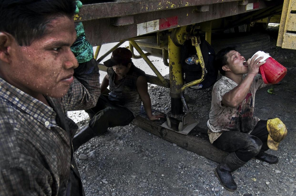 Banana plantation workers in Panama find shade under a vehicle during a break. <a href="https://www.gettyimages.com/detail/news-photo/indian-migrant-workers-rest-in-the-shadow-of-a-transport-news-photo/156543327" rel="nofollow noopener" target="_blank" data-ylk="slk:Jan Sochor/Latincontent/Getty Images;elm:context_link;itc:0;sec:content-canvas" class="link ">Jan Sochor/Latincontent/Getty Images</a>