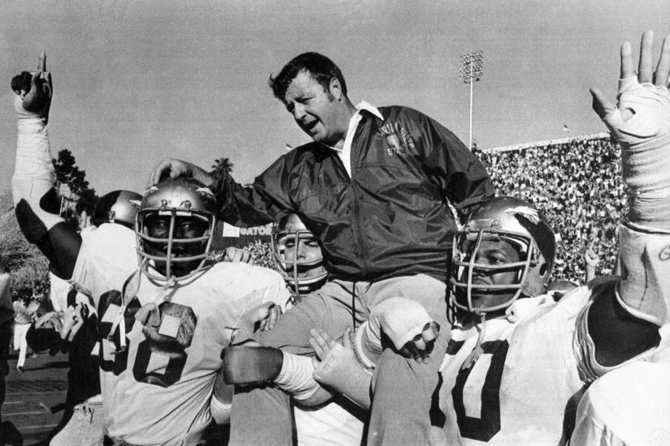 FILE - In this Dec. 3, 1977, file photo, Florida State head coach Bobby Bowden is carried on the shoulders of defensive end Willie Jones (88) and nose guard Ron Simmons (50) after the team defeated Florida 37-9 in a college football game in Gainesville, Fla. Bowden, the folksy Hall of Fame coach who built Florida State into an unprecedented college football dynasty, has died. He was 91. Bobby's son, Terry, confirmed to The Associated Press that his father died at home in Tallahassee, Fla., surrounded by family early Sunday, Aug. 8, 2021. (AP Photo/File)