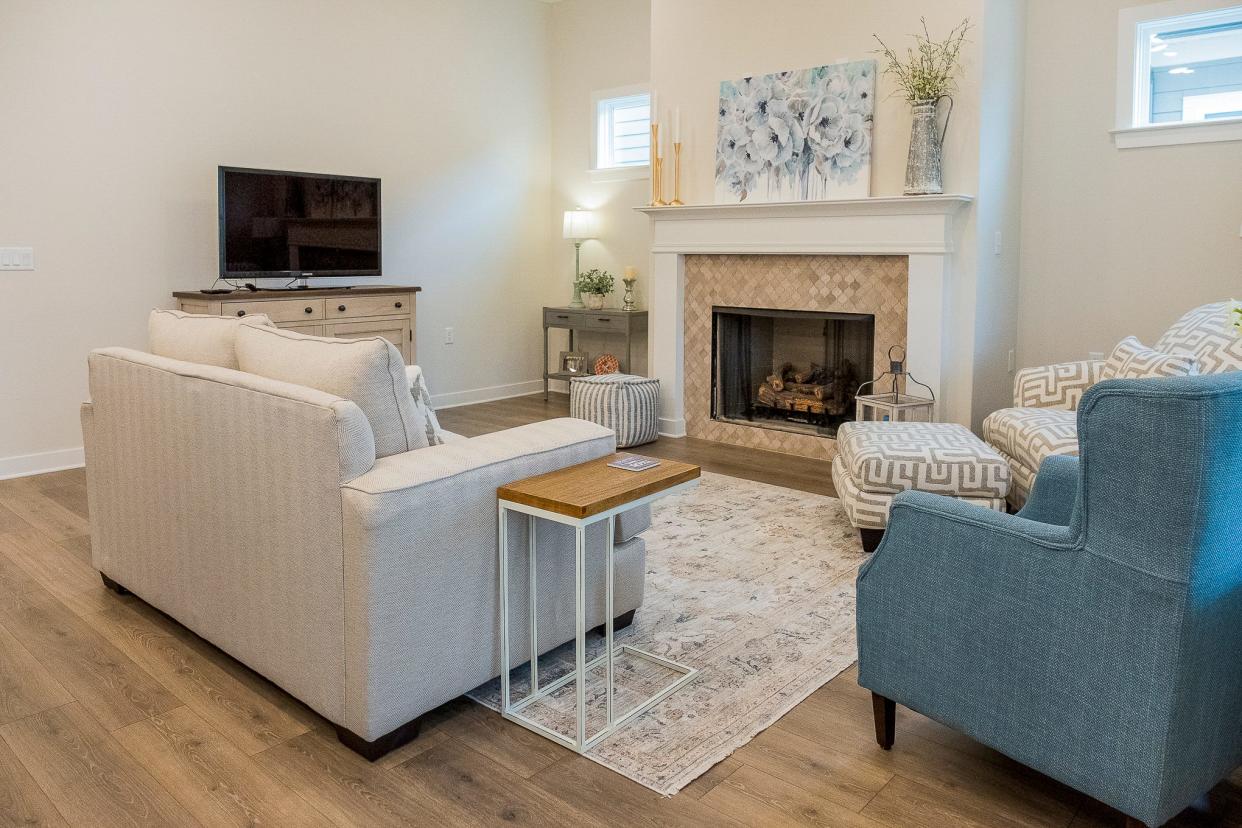The living room is made for comfort with ample seating, a flat screen TV and a working fireplace.