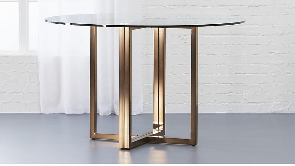 Get it at <a href="https://www.cb2.com/silverado-brass-47-round-dining-table/s593723" target="_blank">CB2, $349</a>.