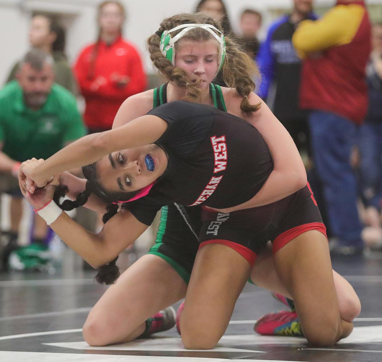 Mogadore 130 pounder Kai Gaetjens, top, bested Olivia Grace of Lutheran West on Thursday, Dec. 28, 2023, in Rocky River, Ohio, at Lutheran West High School's Lady Longhorn Holiday Tournament. [Phil Masturzo/ Beacon Journal]