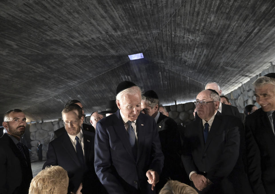 President Joe Biden greets Holocaust survivors Giselle Cycowicz and Rena Quint at the Hall of Remembrance of the Yad Vashem Holocaust Memorial Museum, in Jerusalem, Wednesday July 13, 2022. (Debbie Hill/Pool via AP)