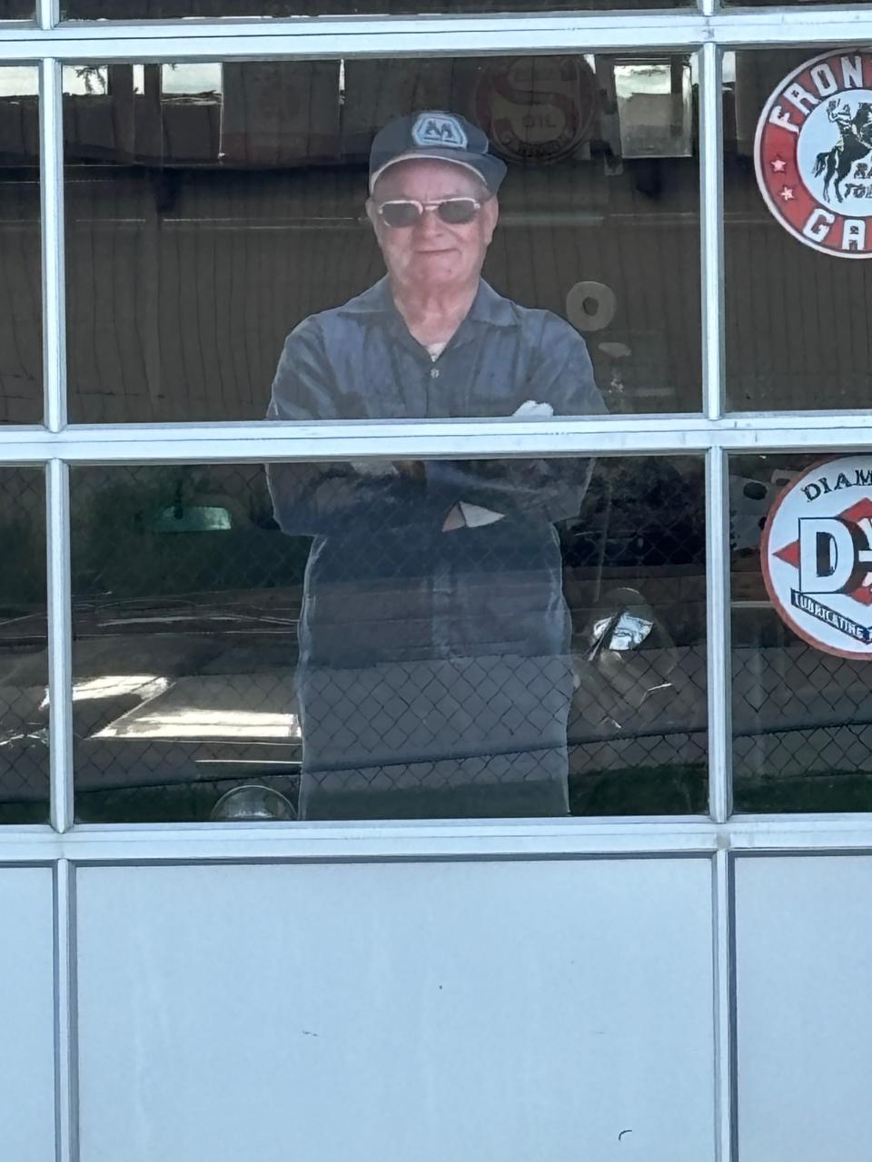 A cardboard cutout of William "Bill" Shea Sr. peers out from one of the bay windows at the former gas station he operated at 2075 Peoria Road. A grand re-opening of the grounds of the building, where Shea also operated a popular Route 66 museum, is set for Monday.