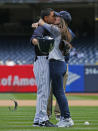 <p>U.S. Army Specialist Daniel Paredes kisses his wife Selena after surprising her on his return from Iraq. Selena threw out the first pitch before game one of a doubleheader between the Houston Astros and New York Yankees at Yankee Stadium on May 14, 2017 in New York City. (Photo by Rich Schultz/Getty Images) </p>