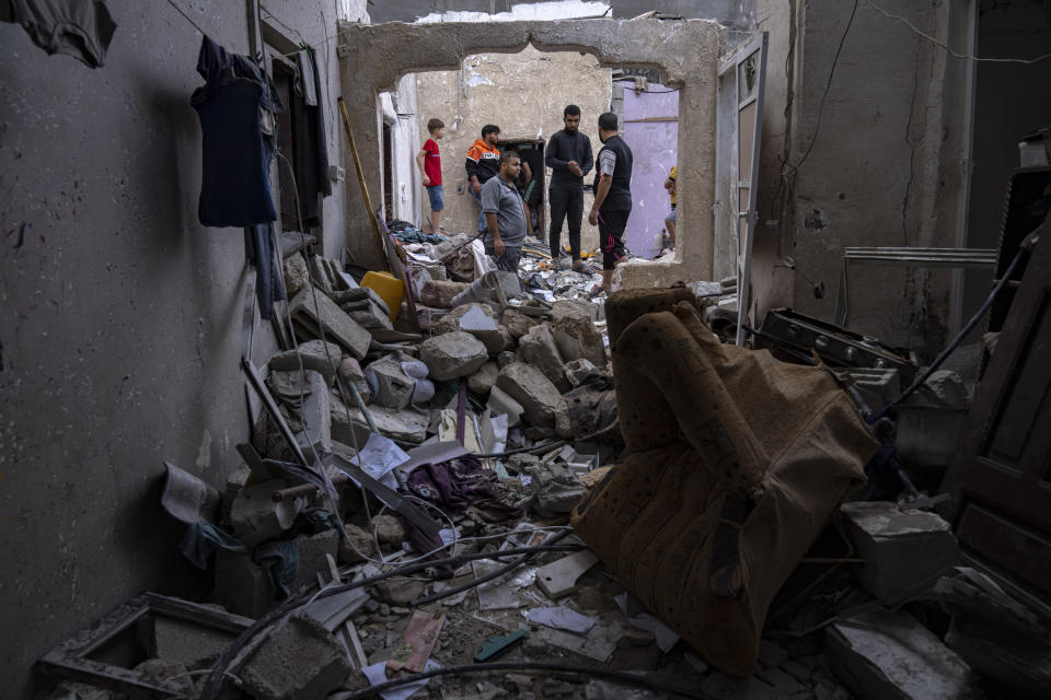 Palestinians inspect the rubble of a house after it was struck by an Israeli airstrike in Khan Younis, southern Gaza Strip, Sunday, Oct. 29, 2023. (AP Photo/Fatima Shbair)