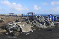 This photo provided by Broadcom Broadcasting shows a damaged area in Nuku'alofa, Tonga, Thursday, Jan. 20, 2022, following Saturday's volcanic eruption near the Pacific archipelago. The first flight carrying fresh water and other aid to Tonga was finally able to leave Thursday after the Pacific nation's main airport runway was cleared of ash left by the eruption. (Marian Kupu/Broadcom Broadcasting via AP)