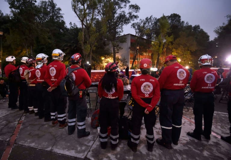 Members of the "Los Topos" (The Moles) rescue team pay homage to the victims of the devastating 1985 earthquake, in Tlatelolco neighbourhood in Mexico City, on September 19, 2018