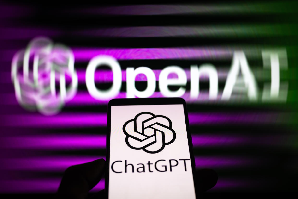 A smartphone displaying ChatGPT with the OpenAI logo in the background is being shown in this photo illustration in Brussels, Belgium, on December 3, 2023. (Photo by Jonathan Raa/NurPhoto via Getty Images)