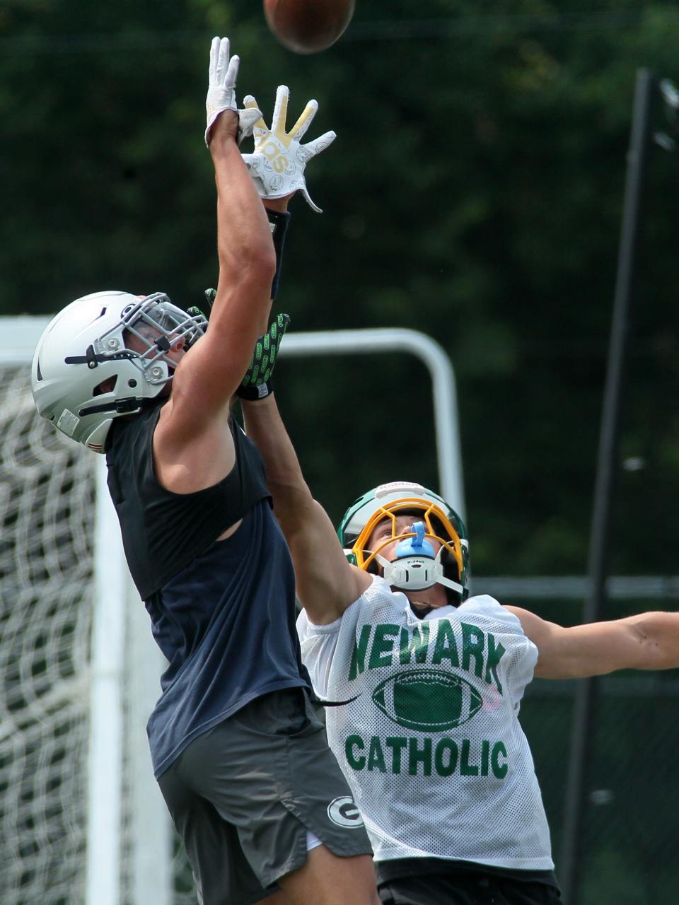 Granville's Dante Varrasso leaps to catch a pass while defended by Newark Catholic's Mikey Hess during a scrimmage on Tuesday.