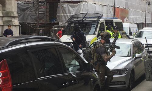 Police from the Tactical Aid Unit prepare to enter a block of flats in Manchester on Wednesday, one of a series of raids following the attack.