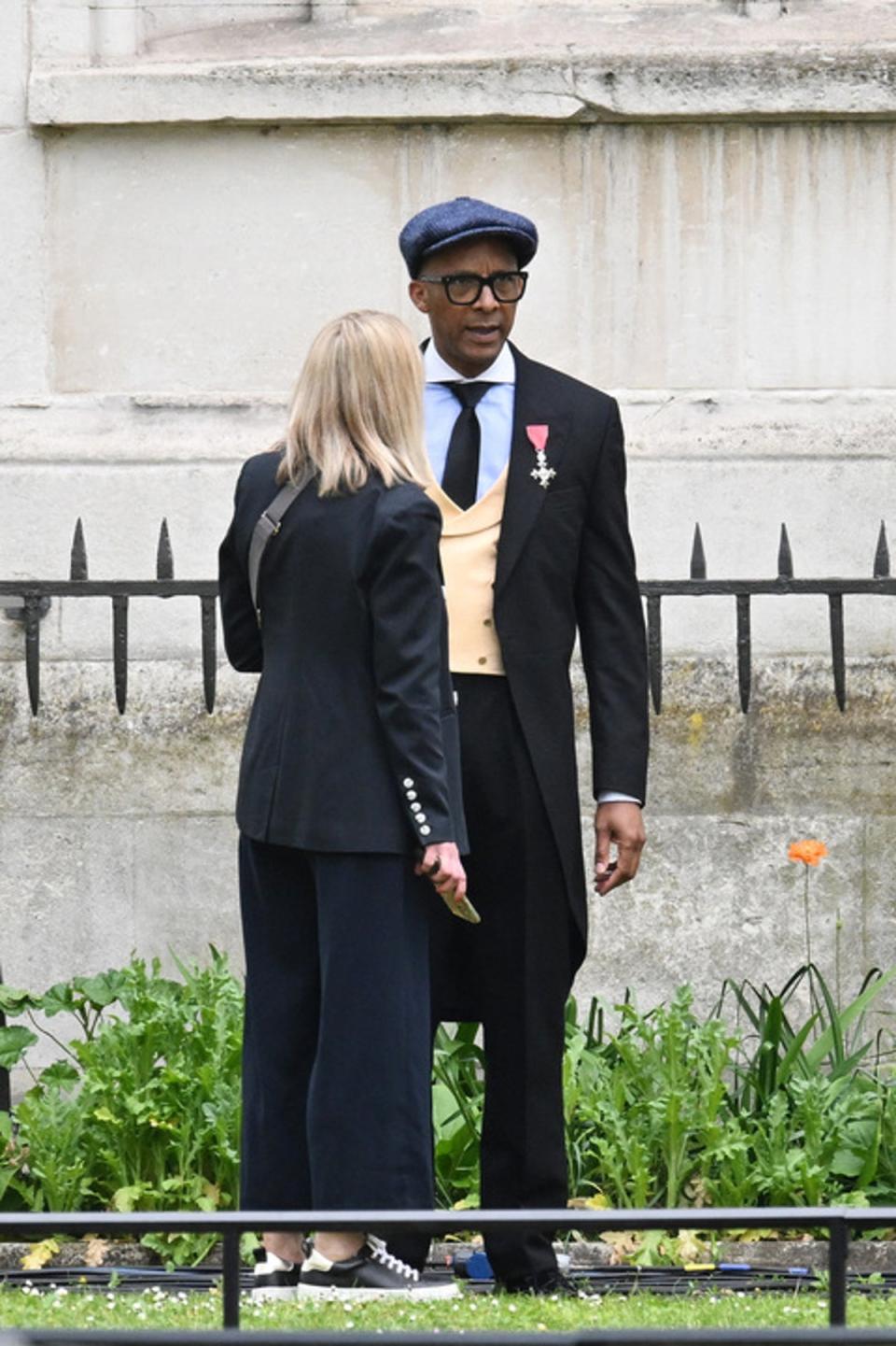 Jay Blades talks with a woman near Westminster Abbey (PA)