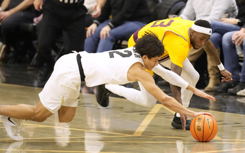 Colorado guard KJ Simpson, front, and Arizona State guard Marreon Jackson scramble for the ball during the first half of an NCAA college basketball game Thursday, Feb. 24, 2022, in Boulder, Colo. (AP Photo/David Zalubowski)