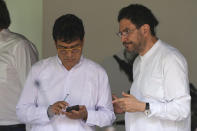 Ivan Danilo Rueda, High Commissioner for Peace on behalf of the Colombian government, left, and government representative Ivan Cepeda, stand together after a signing ceremony agreeing to resume peace talks with the Colombian guerrilla National Liberation Army (ELN), at the Casa Cultural Aquiles Nazoa in Caracas, Venezuela, Tuesday, Oct. 4, 2022. The agreement comes after more than four years of suspension, and will start in November. (AP Photo/Ariana Cubillos)