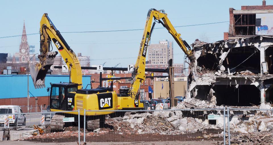 Excavators demolish the former EMI manufacturing facility along West 12th Street in Erie on March 9, 2023.
